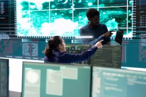 Cybersecurity team monitoring threat detection systems and analyzing data on multiple screens in a high-tech security operations center