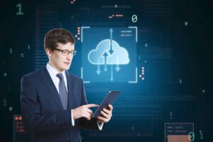 Cloud Engineer managing cloud computing infrastructure on a digital tablet with cloud data hologram