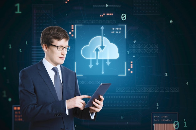 Cloud Engineer managing cloud computing infrastructure on a digital tablet with cloud data hologram